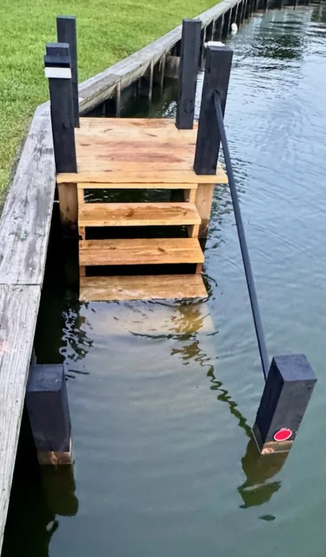 Wooden water-entry steps at Casa Sunset descending directly into Lake Conroe